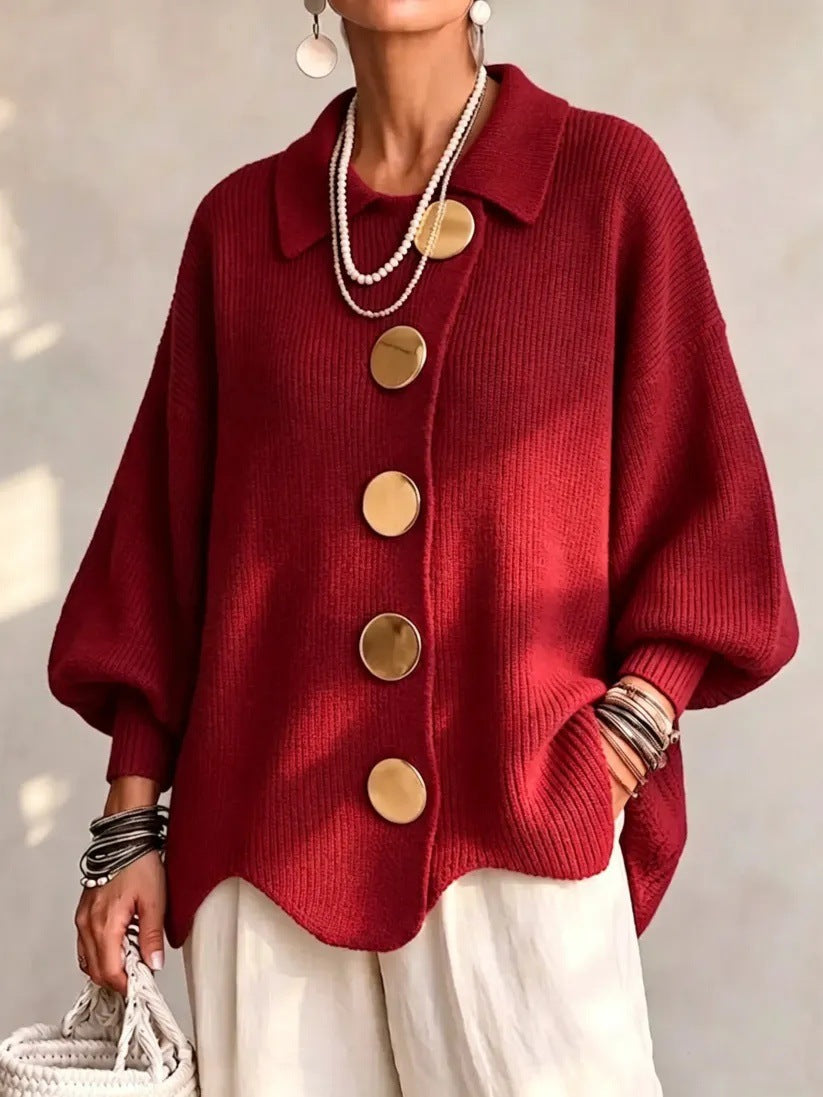 Loose-fitting solid color collared knit sweater with metal buttons and an irregular hem