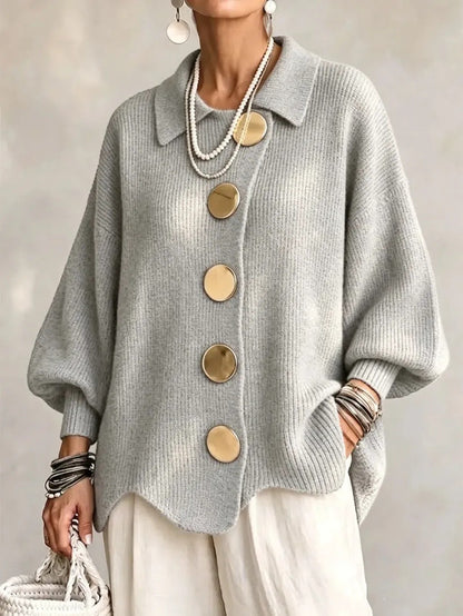 Loose-fitting solid color collared knit sweater with metal buttons and an irregular hem