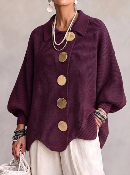 Loose-fitting solid color collared knit sweater with metal buttons and an irregular hem