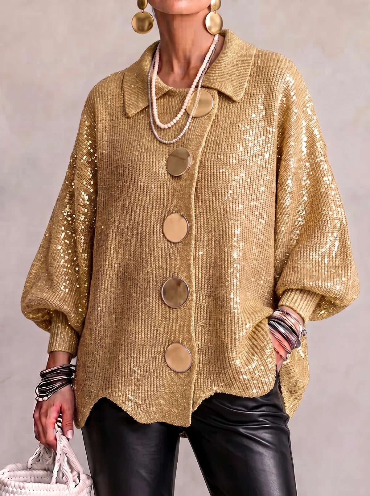 Loose-fitting solid color collared knit sweater with metal buttons and an irregular hem