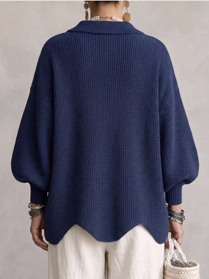 Loose-fitting solid color collared knit sweater with metal buttons and an irregular hem